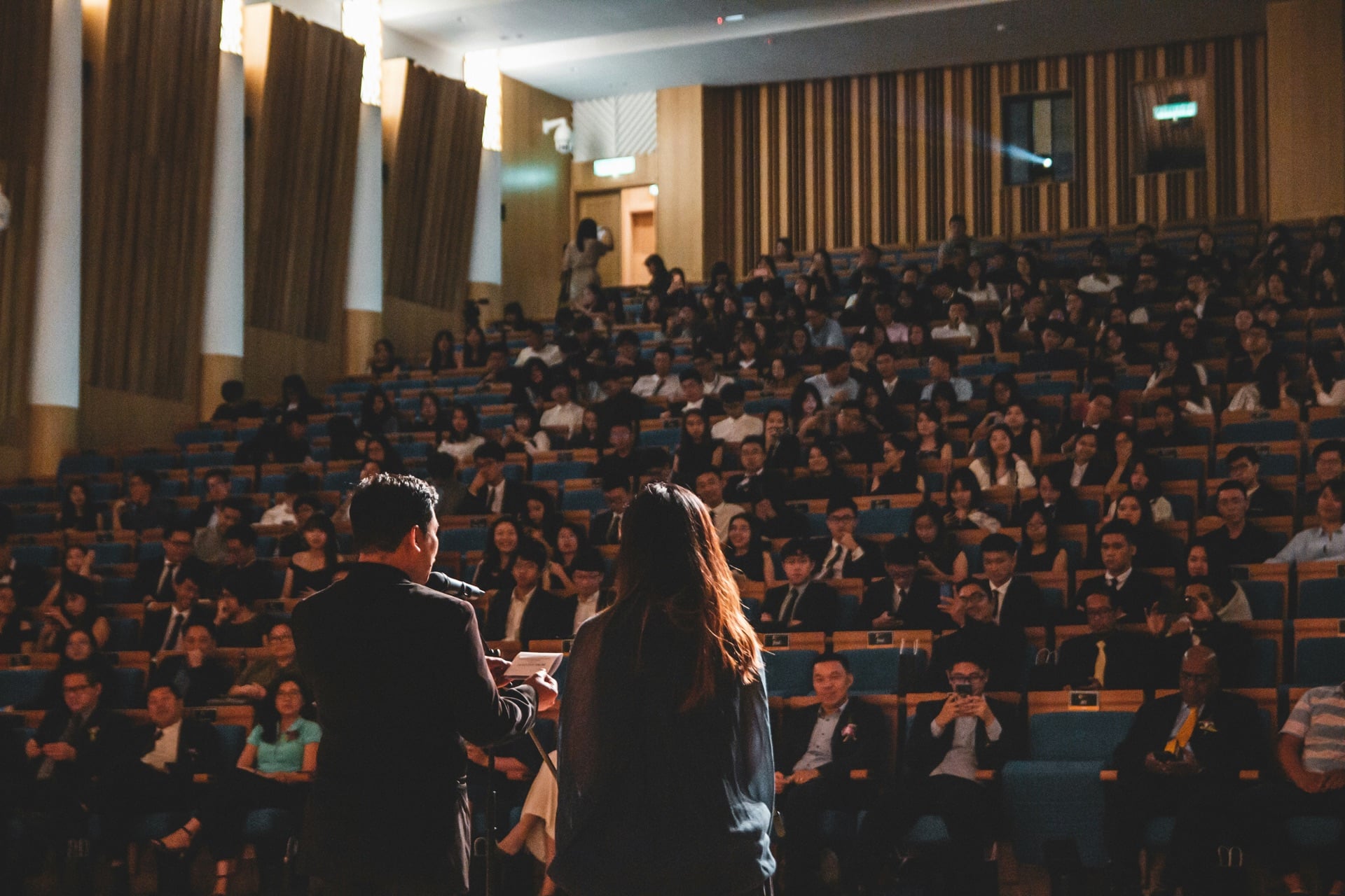 Two speakers presenting to a seated audience